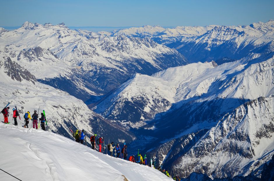 A group of skiers enjoy the stunning snow-covered peaks of Mont Blanc, Chamonix.